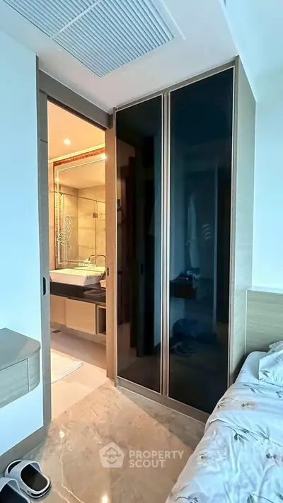 Modern bedroom with ensuite bathroom featuring sleek design and contemporary finishes.