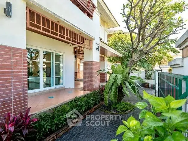 Charming residential exterior with lush garden and spacious patio