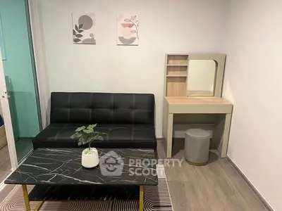 Modern living room with sleek black sofa and stylish coffee table