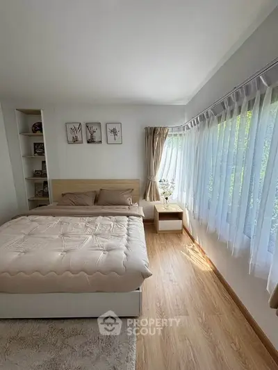 Bright and cozy bedroom with large windows and elegant decor