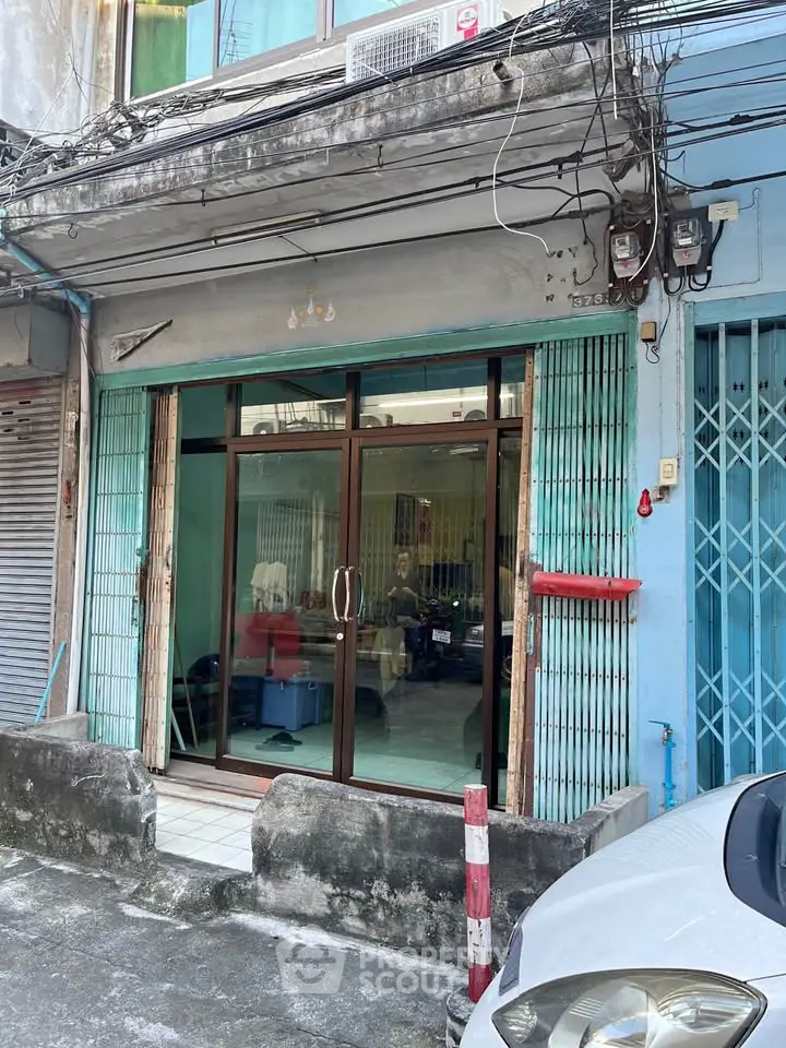 Charming urban storefront with glass doors and vibrant blue facade, perfect for small business opportunities.