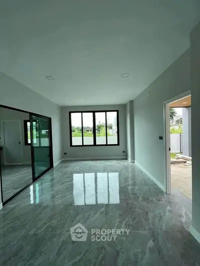 Spacious empty room with large windows and glossy tiled floor, perfect for customization.