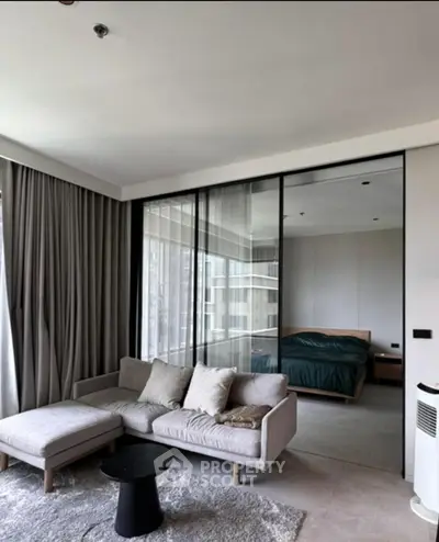 Modern living room with glass partition and cozy seating area