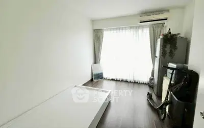 Minimalist bedroom with large window, air conditioning, and sleek flooring, perfect for modern living.