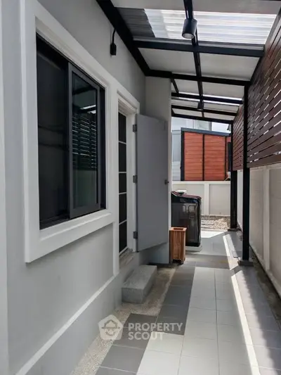 Modern exterior corridor with sleek design and natural light, featuring a stylish covered walkway.