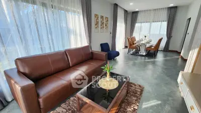 Spacious modern living room with elegant dining area and natural light