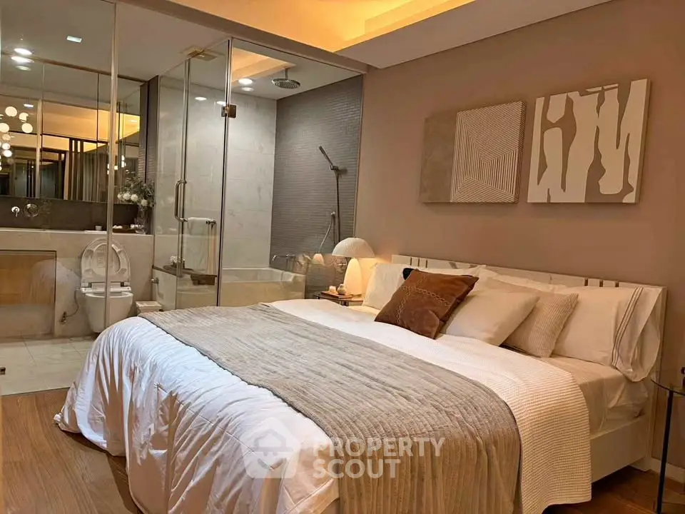 Luxurious bedroom with ensuite bathroom featuring modern decor and ambient lighting.