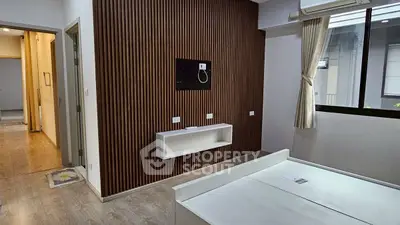 Modern bedroom with wood panel accent wall and large window