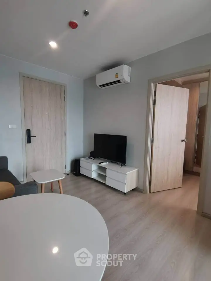 Modern living room with sleek furniture and air conditioning unit