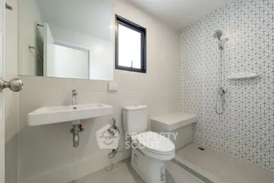 Modern bathroom with geometric tile design and sleek fixtures