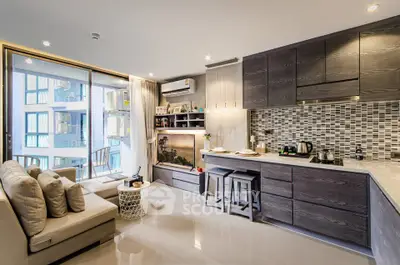 Modern open-plan living room with stylish kitchen and balcony view
