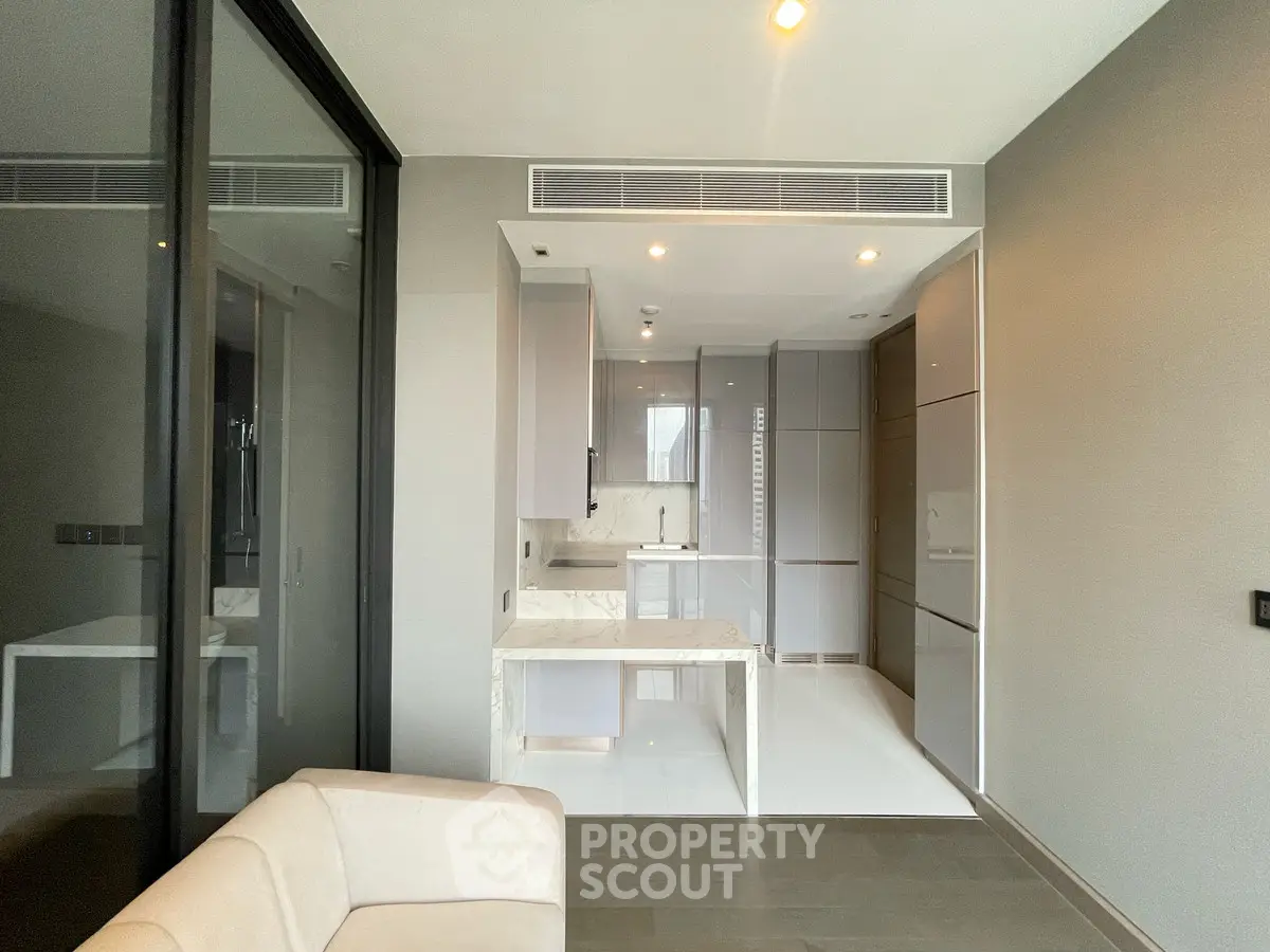 Modern minimalist kitchen with sleek cabinetry and marble accents