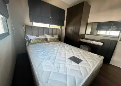 Modern bedroom with stylish decor and ample natural light, featuring a comfortable bed and sleek furnishings.