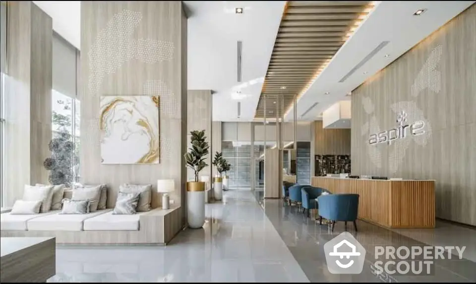 Luxurious modern lobby with elegant decor and high ceilings in upscale building.