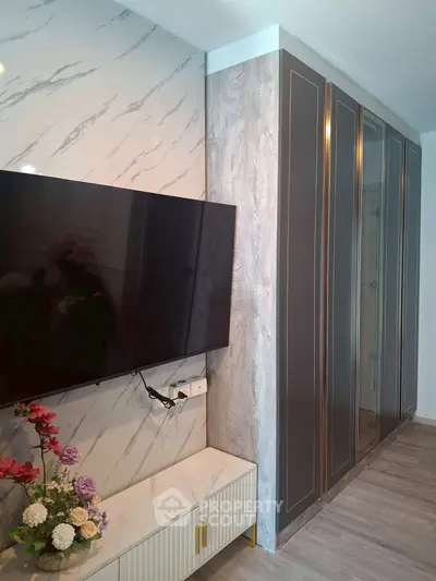 Modern living room with sleek TV setup and elegant cabinetry