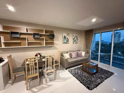 Modern living room with stylish decor and city view balcony