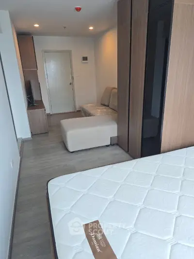 Modern studio apartment with cozy living area and stylish furniture