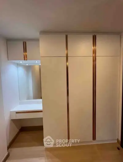 Modern bedroom with built-in wardrobe and vanity area