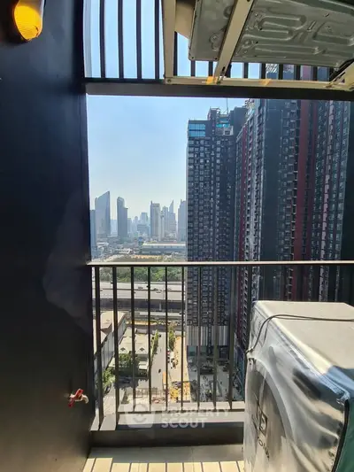 Stunning cityscape view from a high-rise balcony with modern urban architecture.
