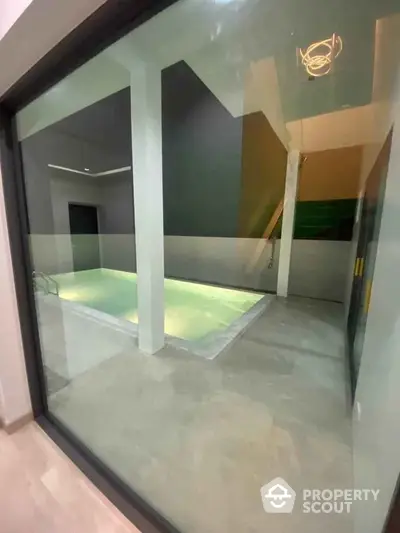 Modern indoor pool with sleek design and ambient lighting