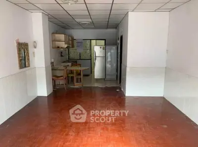 Spacious open layout kitchen with dining area and wooden flooring