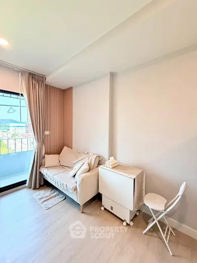 Bright and cozy living room with modern decor and balcony view