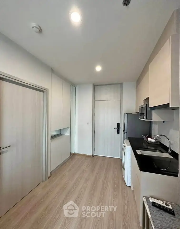 Modern kitchen with sleek cabinetry and built-in appliances in a compact layout.