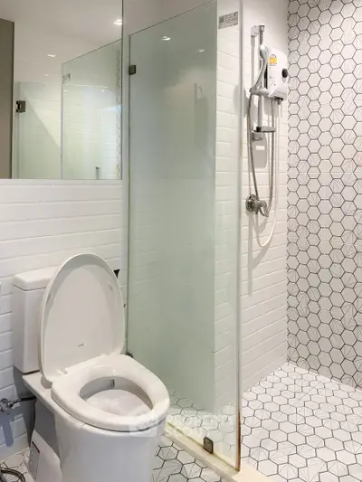 Modern bathroom with glass shower and geometric tile design