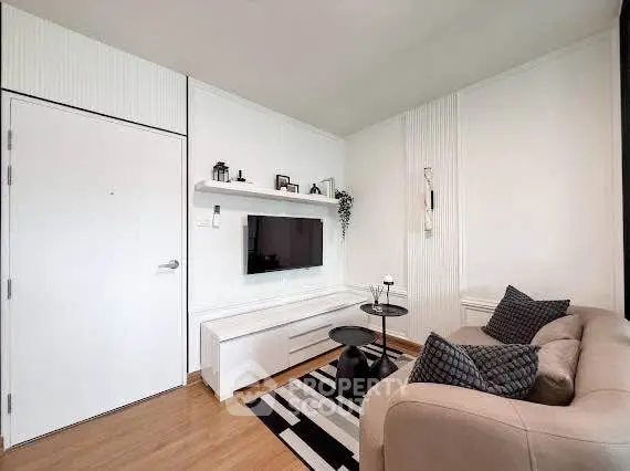 Modern living room with sleek furniture and wall-mounted TV, perfect for stylish urban living.