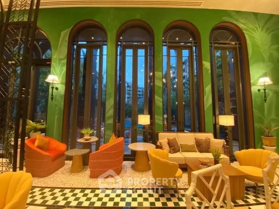 Luxurious living room with vibrant decor and tall arched windows offering a stunning view.