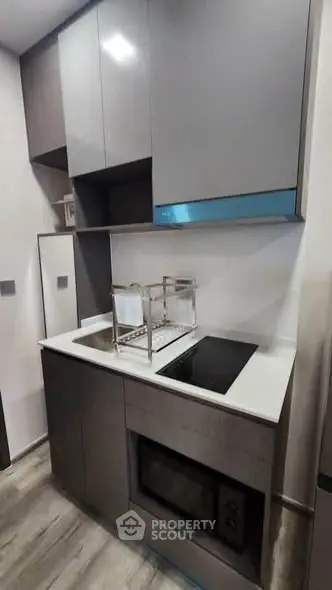Modern compact kitchen with sleek cabinetry and built-in appliances