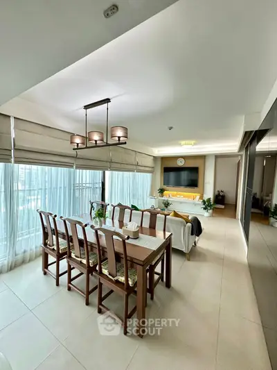 Spacious dining and living area with elegant decor and large windows.