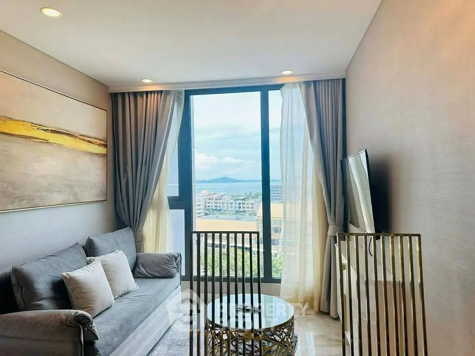 Modern living room with large window offering stunning city view, elegant decor, and cozy seating area.