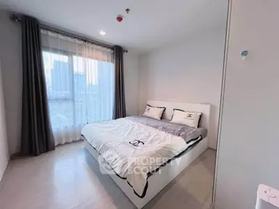 Modern bedroom with large window and stylish decor in urban apartment