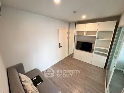 Modern living room with sleek built-in shelving and cozy seating area.