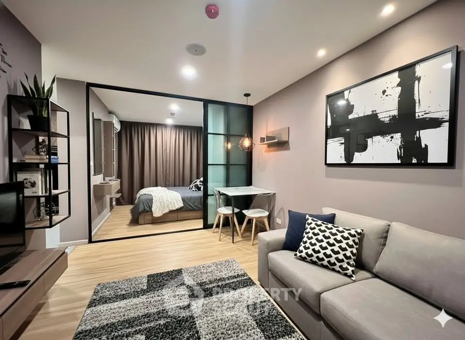 Modern open-plan living room with stylish decor and cozy bedroom view