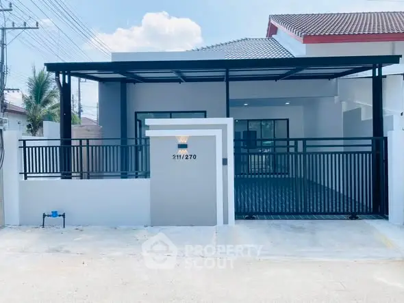 Modern single-story house with sleek metal gate and covered carport in a suburban neighborhood.