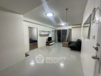 Spacious modern living room with sleek tile flooring and balcony access