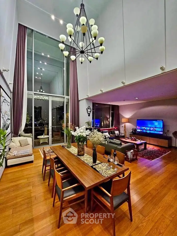 Luxurious high-ceiling living room with elegant chandelier and modern decor