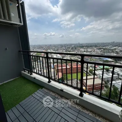 Stunning high-rise balcony with panoramic city views and artificial grass flooring.