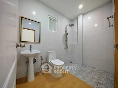 Spacious modern bathroom with sleek fixtures and walk-in shower