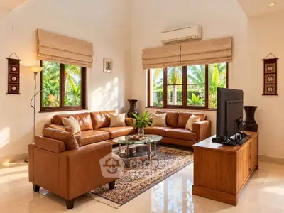 Luxurious living room with leather sofas and tropical garden view