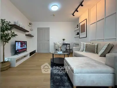 Modern living room with stylish decor, cozy sectional sofa, and mounted TV, perfect for relaxation and entertainment.