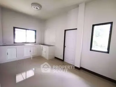 Spacious unfurnished kitchen with modern fixtures and ample natural light.