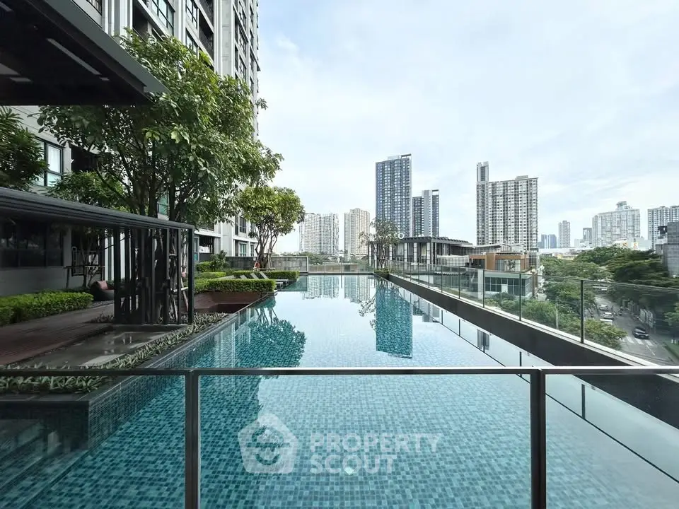 Luxurious rooftop pool with stunning city skyline views in modern high-rise building.