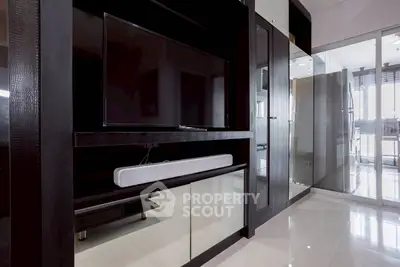 Modern living room with sleek black entertainment unit and glossy floors