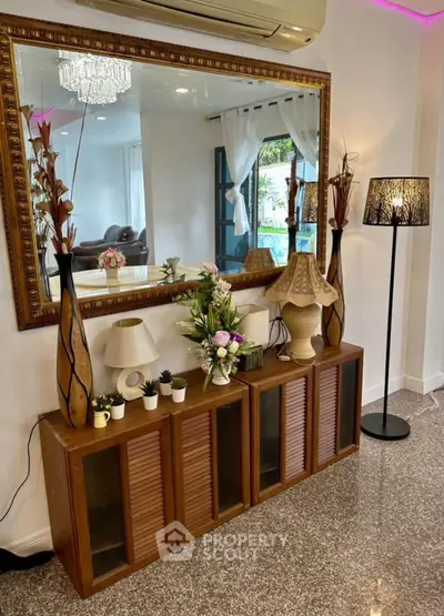 Elegant living room with stylish decor, large mirror, and ambient lighting