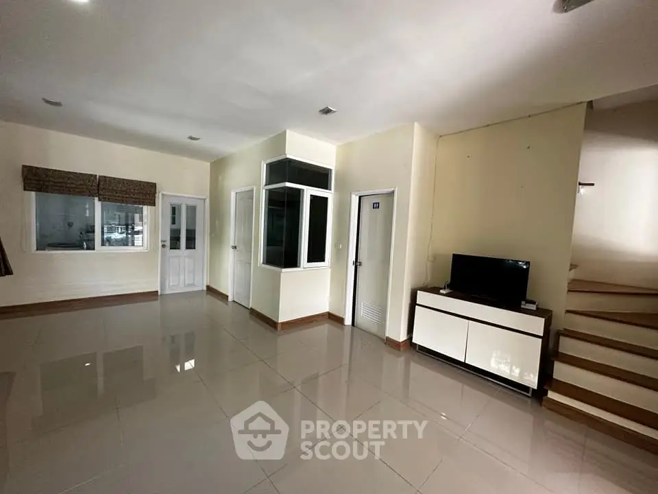 Spacious modern living room with sleek tile flooring and natural light