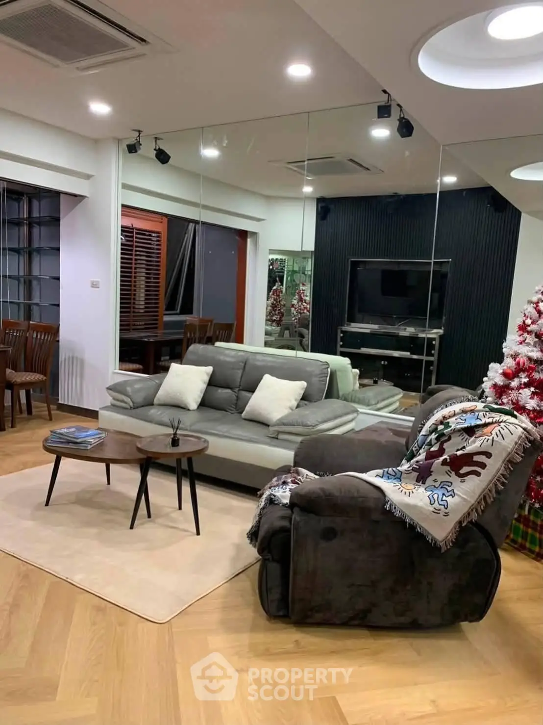 Stylish living room with modern furniture and Christmas decor, perfect for cozy gatherings.