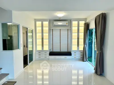 Bright and modern living room with large windows and built-in storage